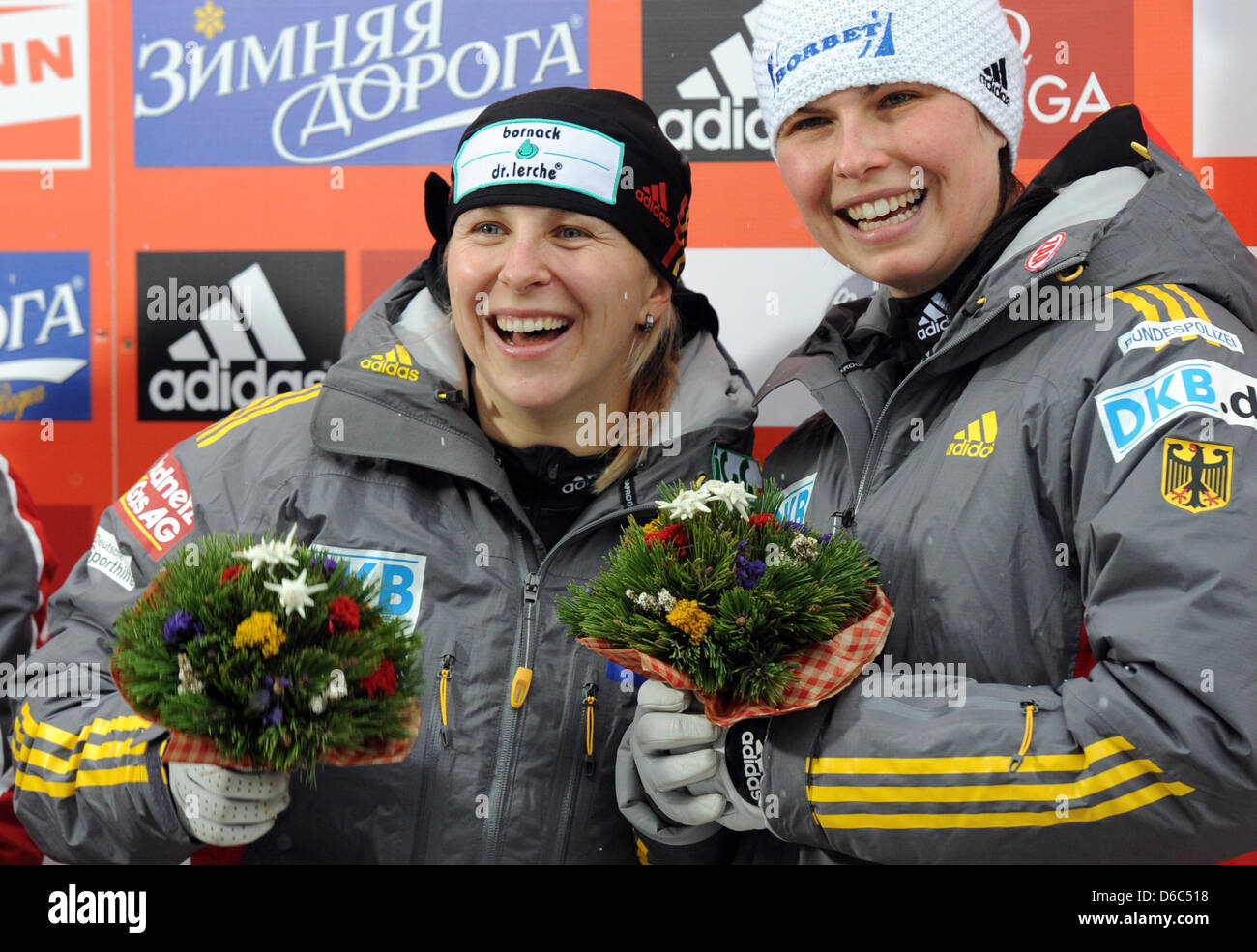 German bobsledders Cathleen Martini (L) and Berit Wiacker celebrate their victory during the awards ceremony at the women's two-person bobsleigh world cup in Koenigssee, Germany, 13 January 2012. Martini and Wiacker came in first place. Photo: TOBIAS HASE Stock Photo