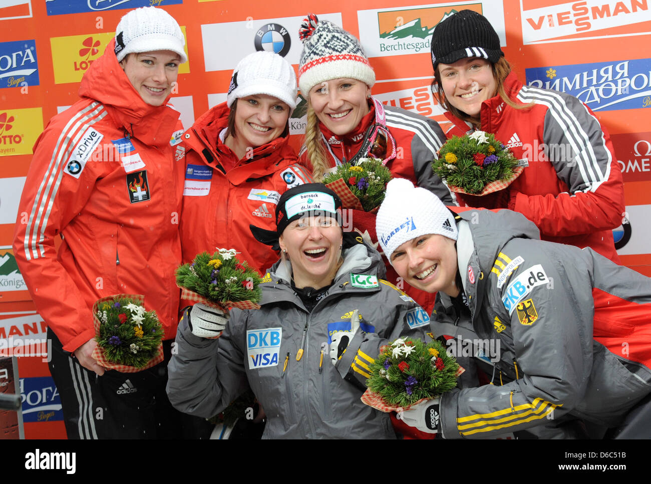 Bobsledders Hanne Schenk (back, L-R) and Fabienne Meyer from Switzerland, Kaillie Humphries and Emily Baadsvik from Canada and   Cathleen Martini (below, L-R) and Berit Wiacker from Germany celebrate their victories during the awards ceremony at the women's two-person bobsleigh world cup in Koenigssee, Germany, 13 January 2012. Martini and Wiacker came in first place in front of Sw Stock Photo
