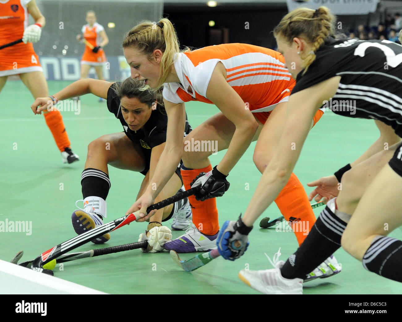 Netherland's Lieke Hulsen (M) vies for the ball with Germany's Rebecca Landshut (L) and Dinah Grote during the Field Hockey Indoor European Championships semi-final match between The Netherlands and Germany at the Arena in Leipzig, Germany, 14 January 2012. Photo: HENDRIK SCHMIDT Stock Photo