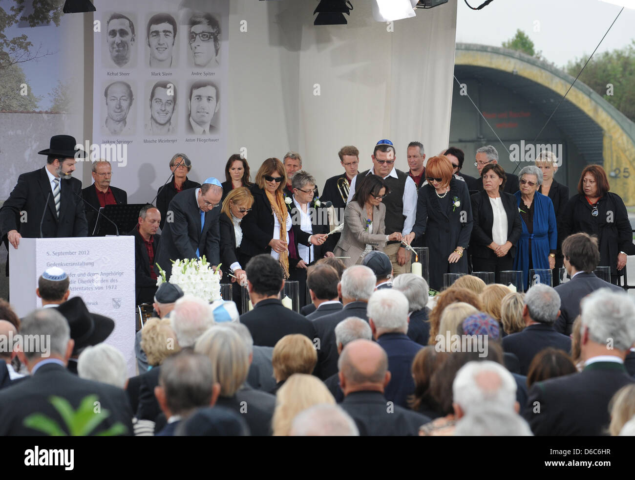 Relatives of the victims of the 1972 Munich Olympics massacre stand on stage after having lit up candles during the commemorative event for the victims of the Munich Olympic 1972 shootings at the air base in Fuerstenfeldbruck, Germany, 05 September 2012. On 05 September 1972, gunmen broke into the Israeli team's flat at the Olympic village, immediately killing two of the athletes a Stock Photo