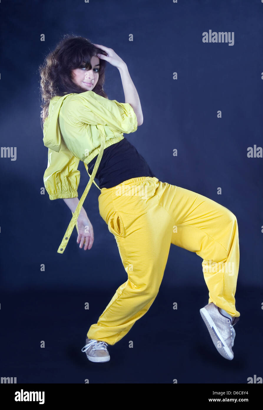 Brunette posing in hip hop outfit Stock Photo - Alamy