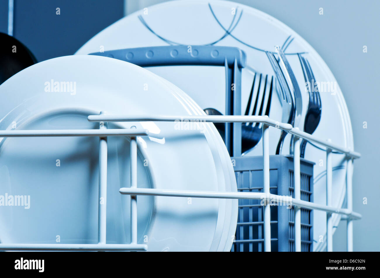 Clean plates and forks inside dishwasher Stock Photo Alamy
