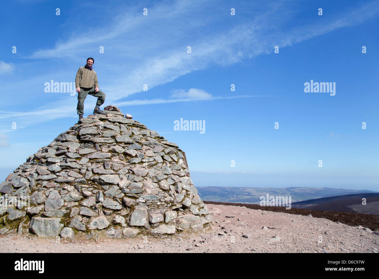 Dunkery Beacon; David Chapman on the Summit Cairn; Exmoor; UK Stock Photo