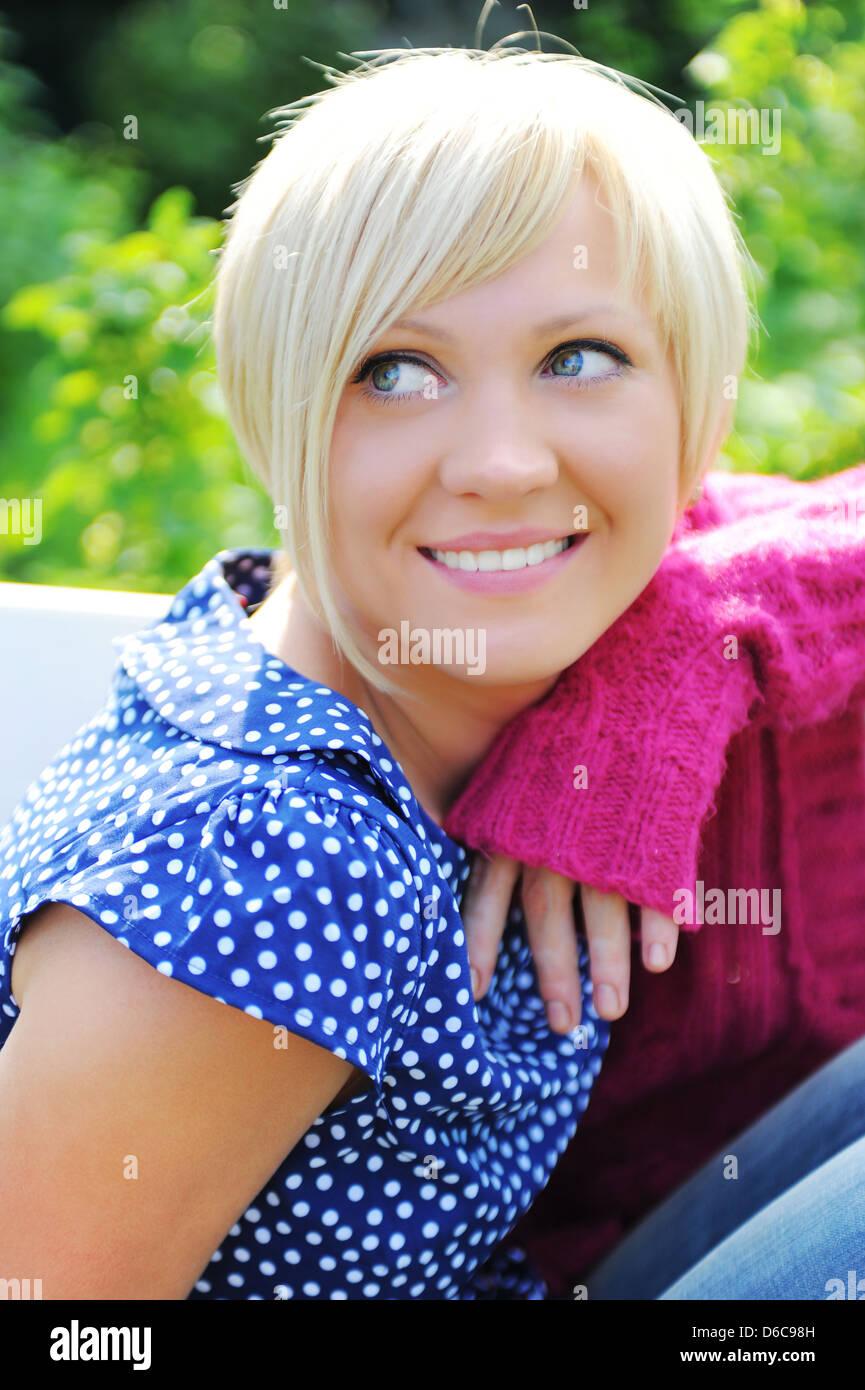 Young woman relaxing in a park Stock Photo - Alamy