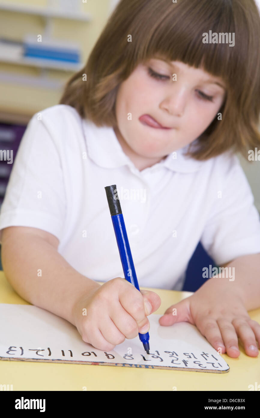 writing,learning,schoolgirl,schoolchild,concentrated Stock Photo
