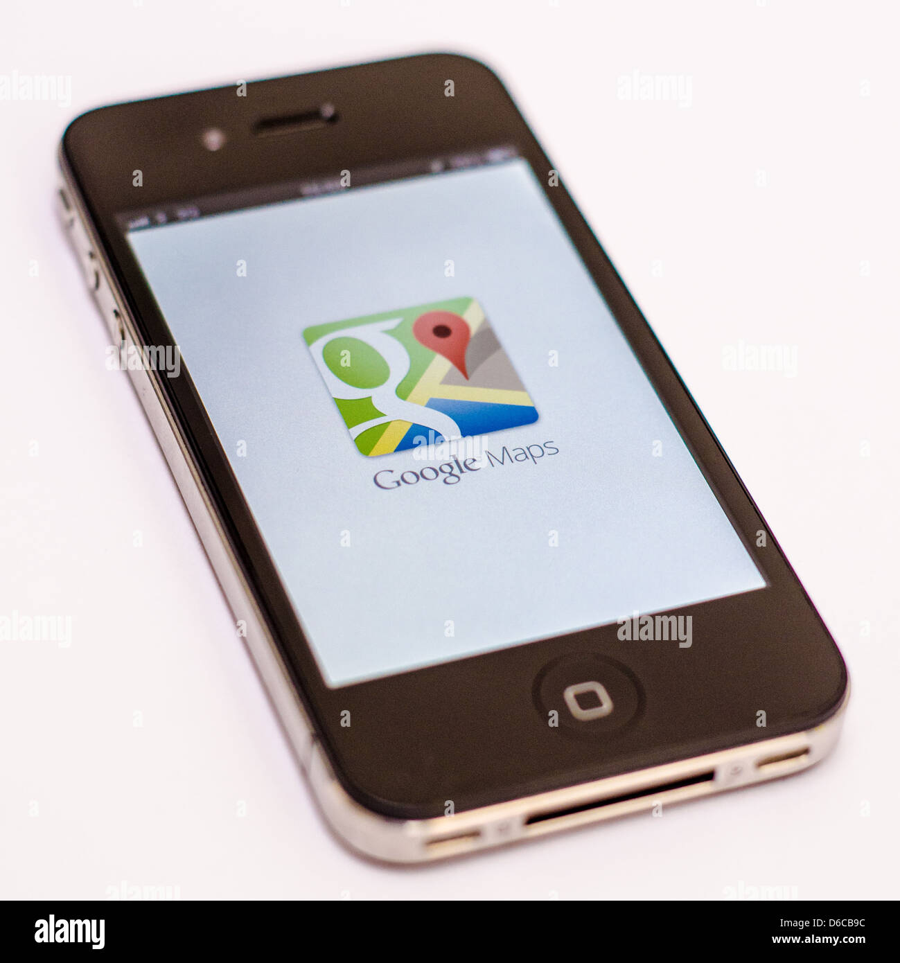 Apple iPhone on white background showing the Google Maps application. Stock Photo