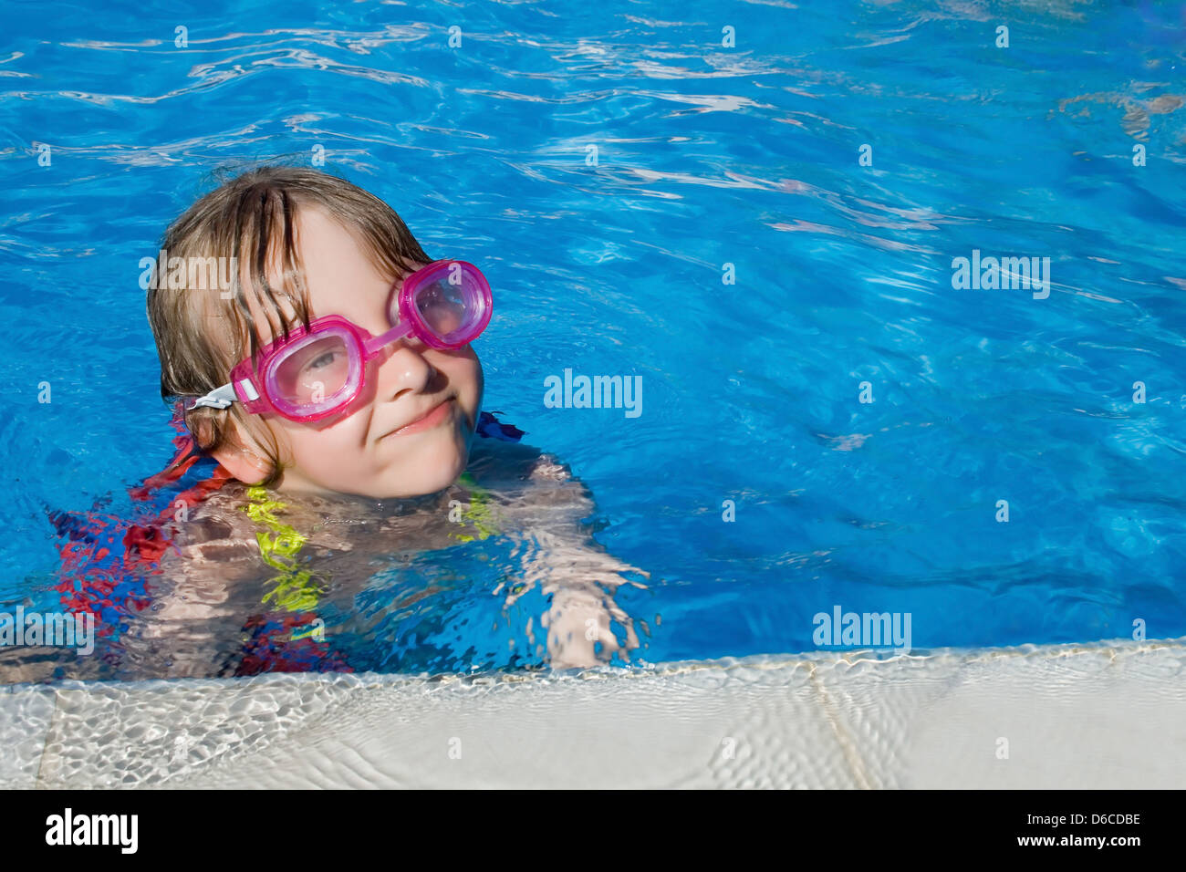 Little girl swimming in pool with goggles Stock Photo Alamy