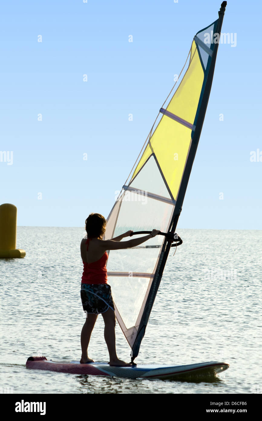 A women on a windsurf on waves Stock Photo