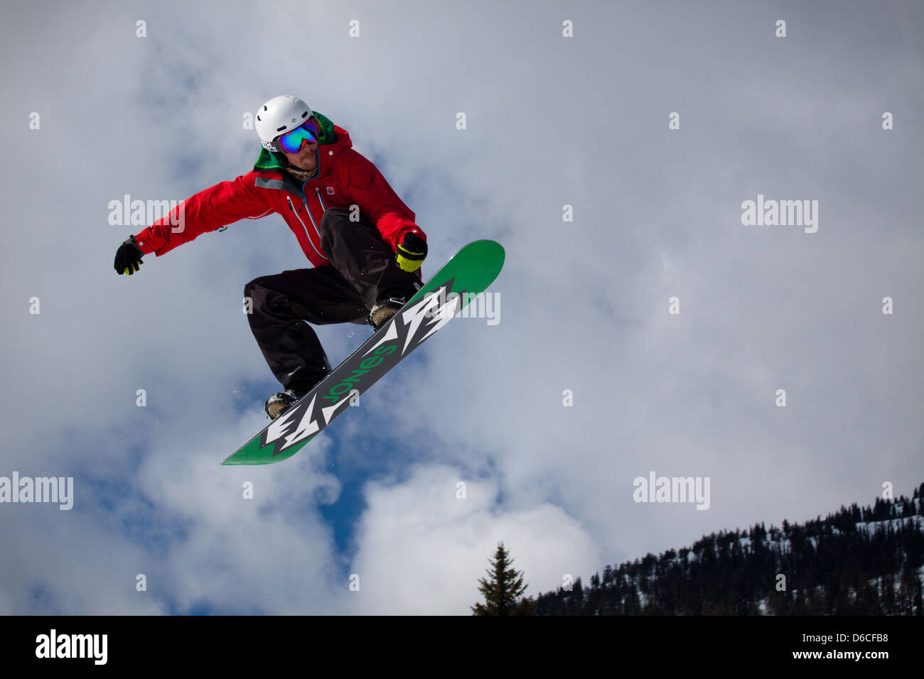 A boarder makes a jump at Red Mountain resort, Canada Stock Photo
