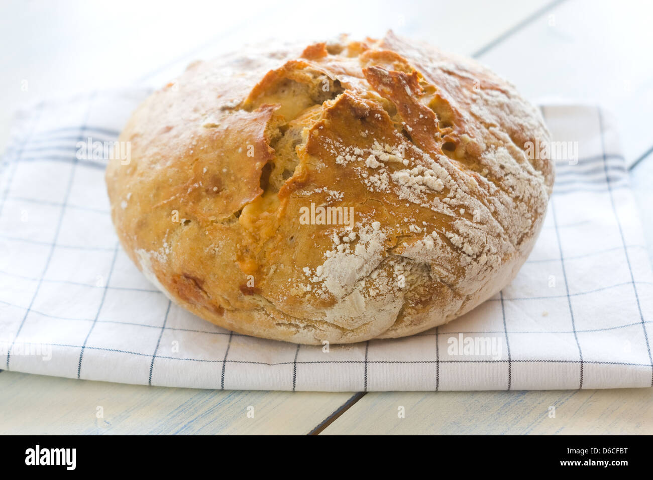 A freshly baked loaf of homemade bread with ripe cheese and walnuts. Thin depth of field Stock Photo