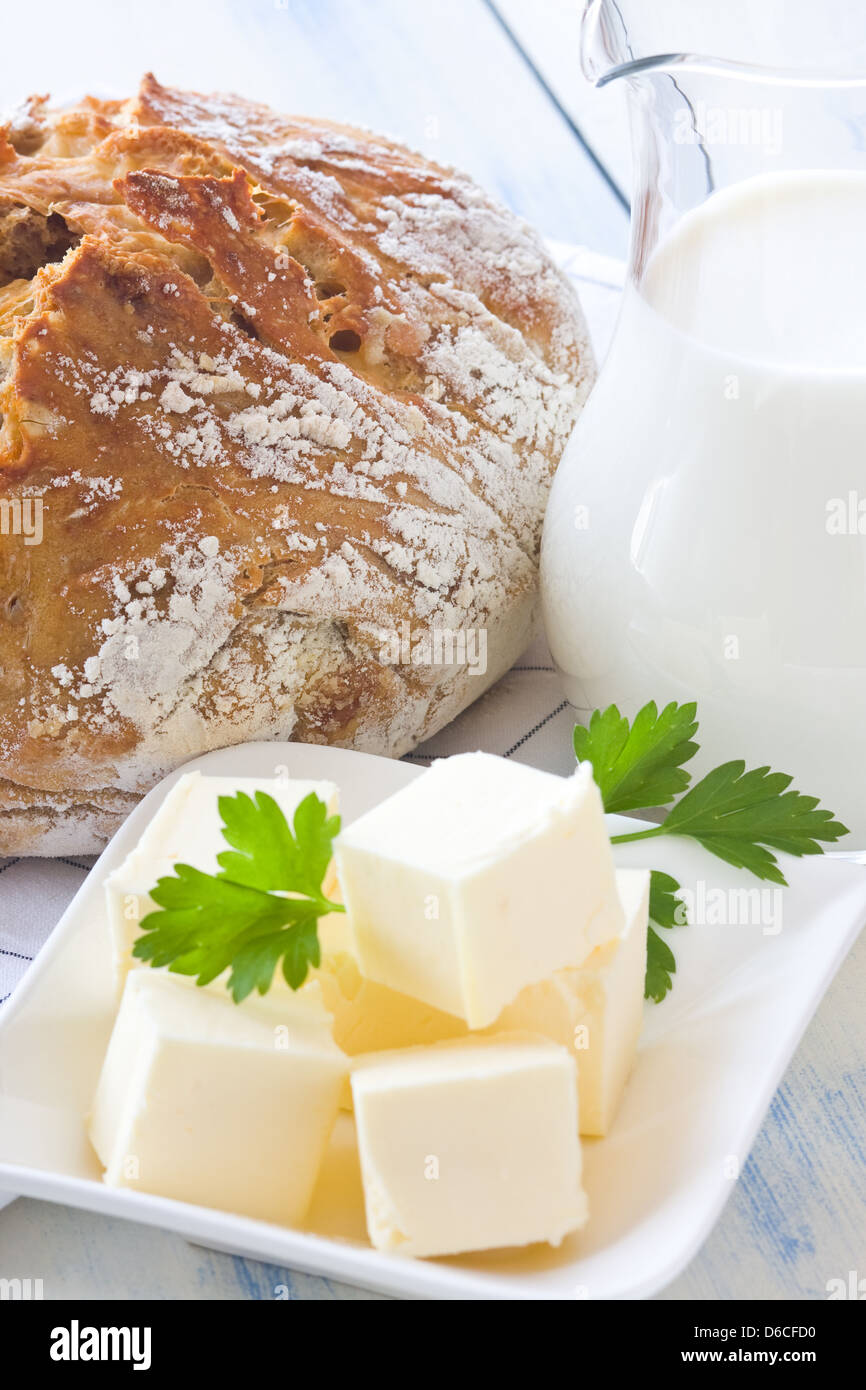 A freshly baked loaf of homemade bread with ripe cheese and walnuts. Focus on bread Stock Photo