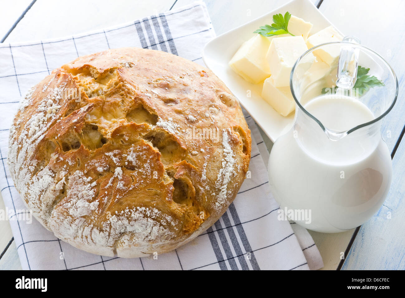 A freshly baked loaf of homemade bread with ripe cheese and walnuts Stock Photo