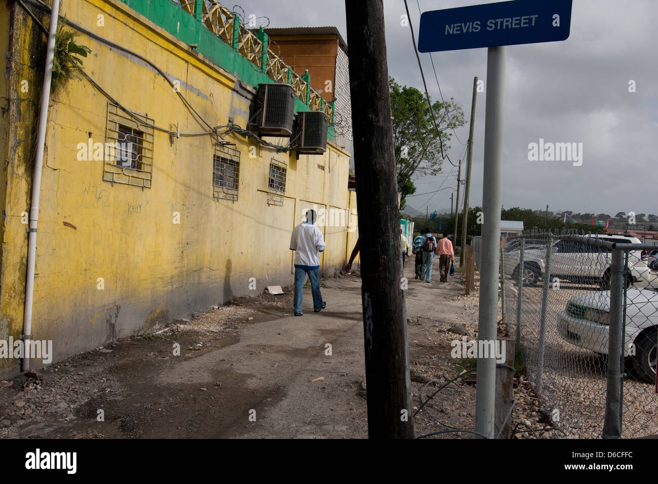 People walk in an alley off Nevis Street in Antigua Stock Photo