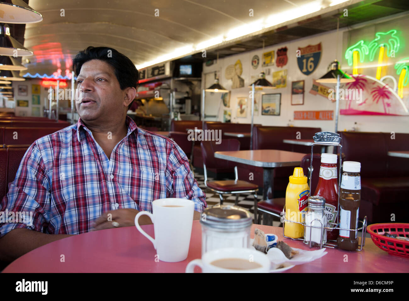 Customer sitting at a table at Starvin Marvin's Diner London Stock Photo