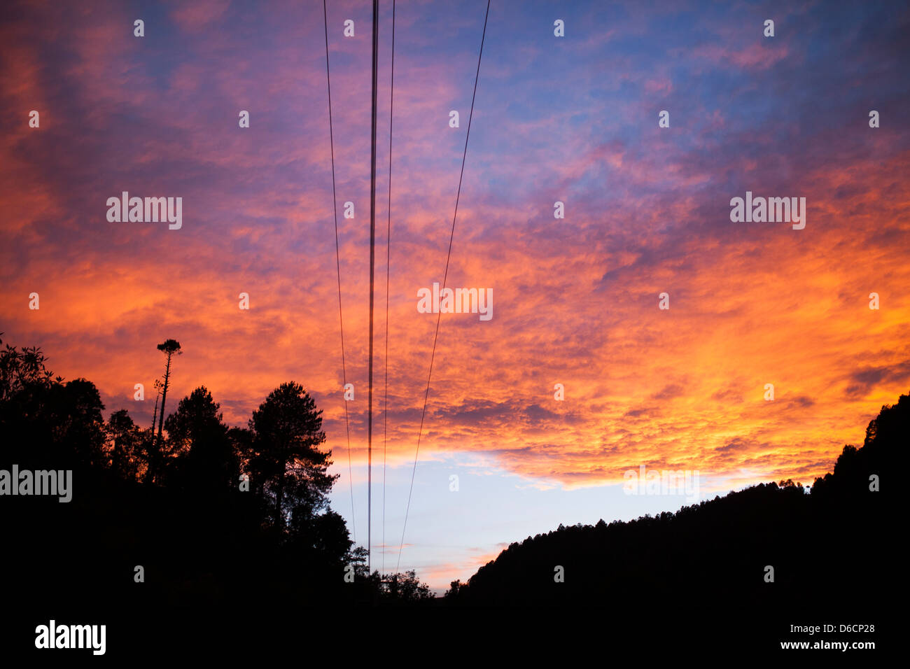 A firey sunset takes over the Oaxaca sky in the Sierra Mixe. Stock Photo