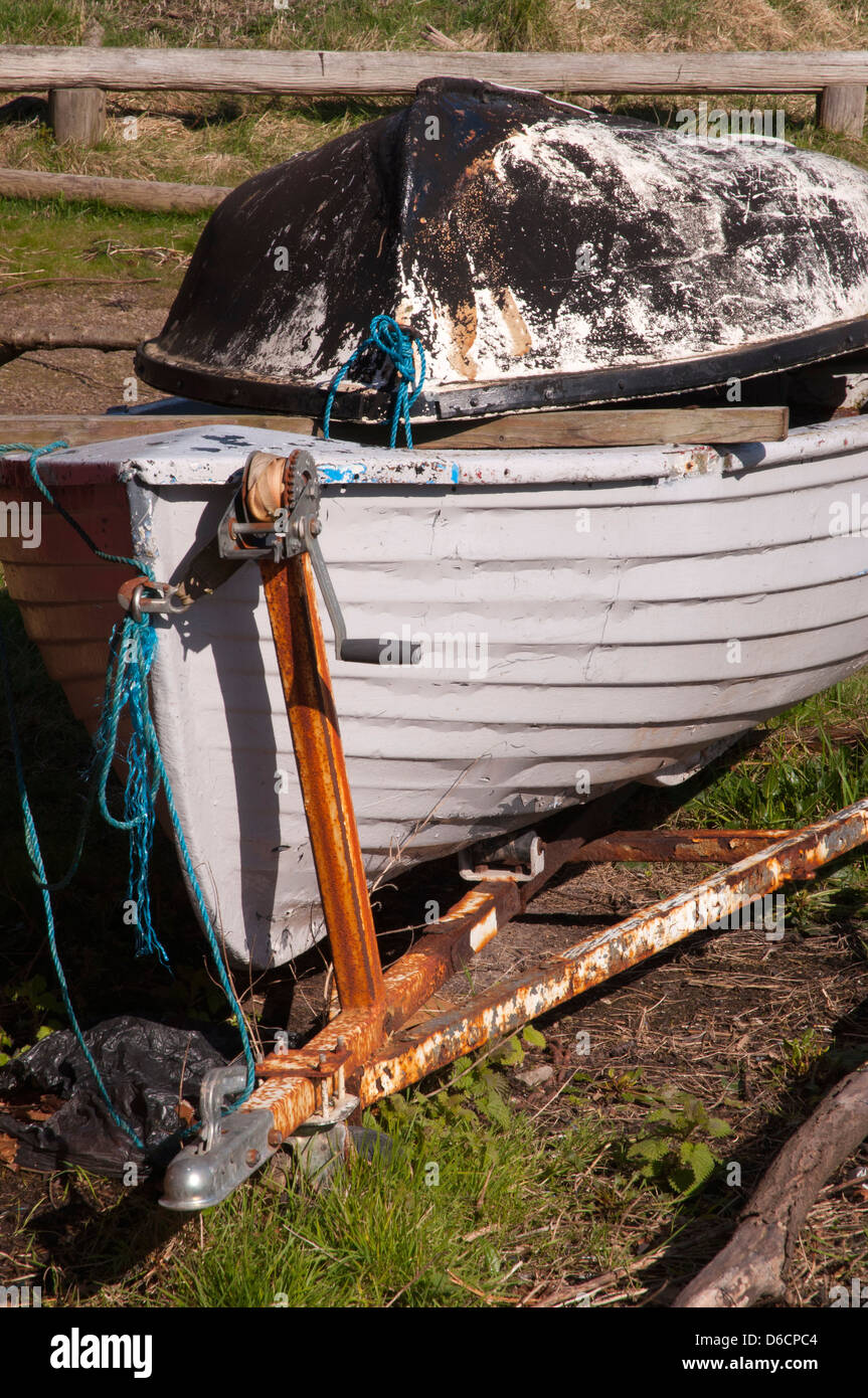 wooden boat in progress of repairs, old boat trailer, rusted, semi