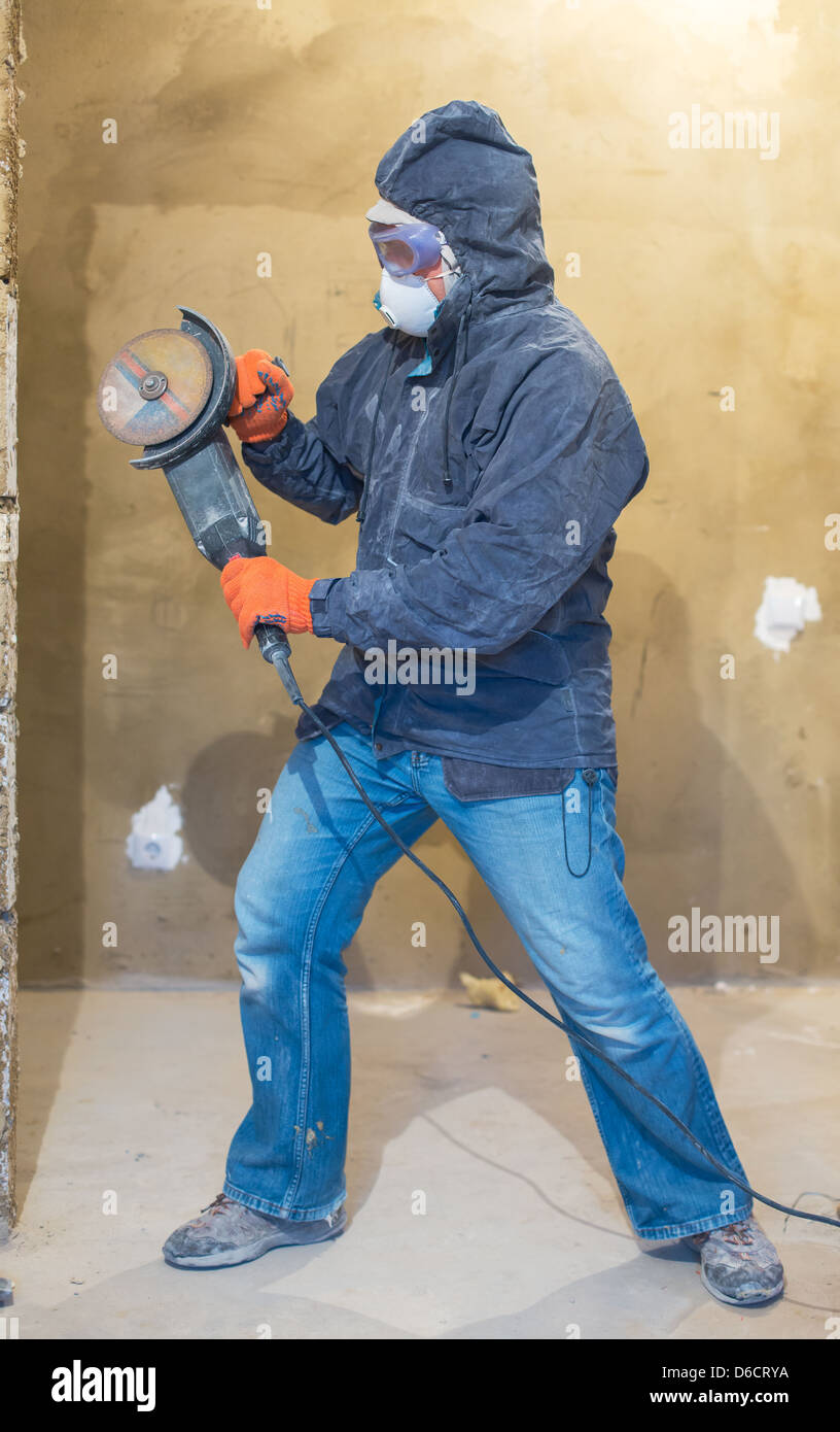 Repairman with grinder Stock Photo