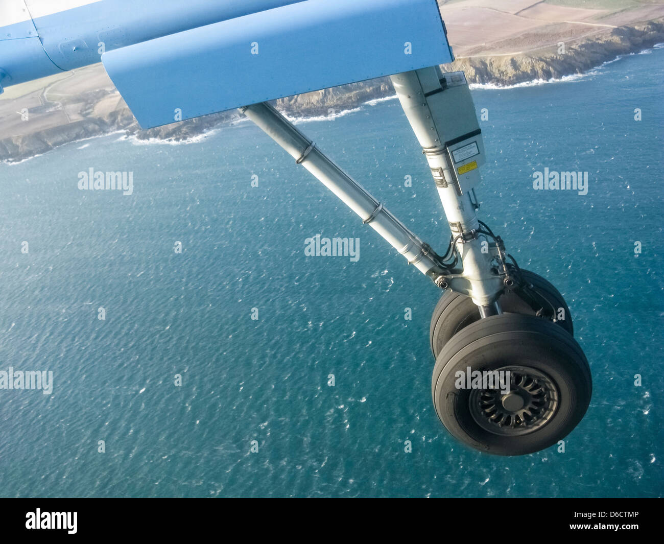 Landing gear of plane on its approach to landing,over the sea.It is a