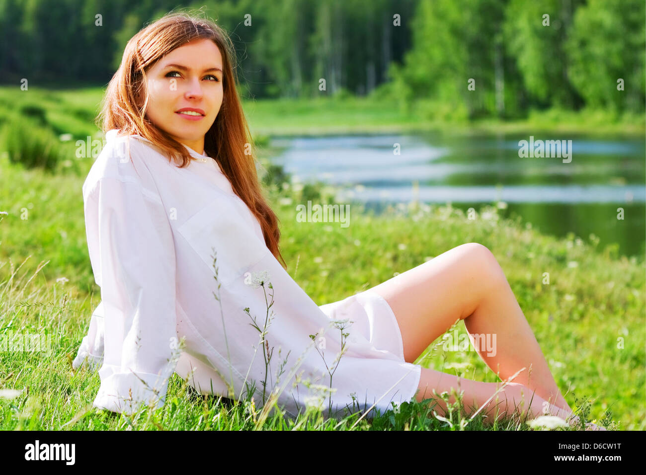 Happy young woman relaxing on nature Stock Photo - Alamy