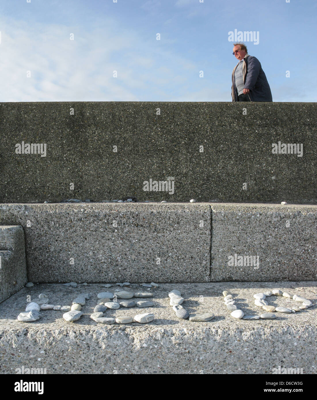 The word 'Hello' made out of beach pebbles arranged in the sun on a ...