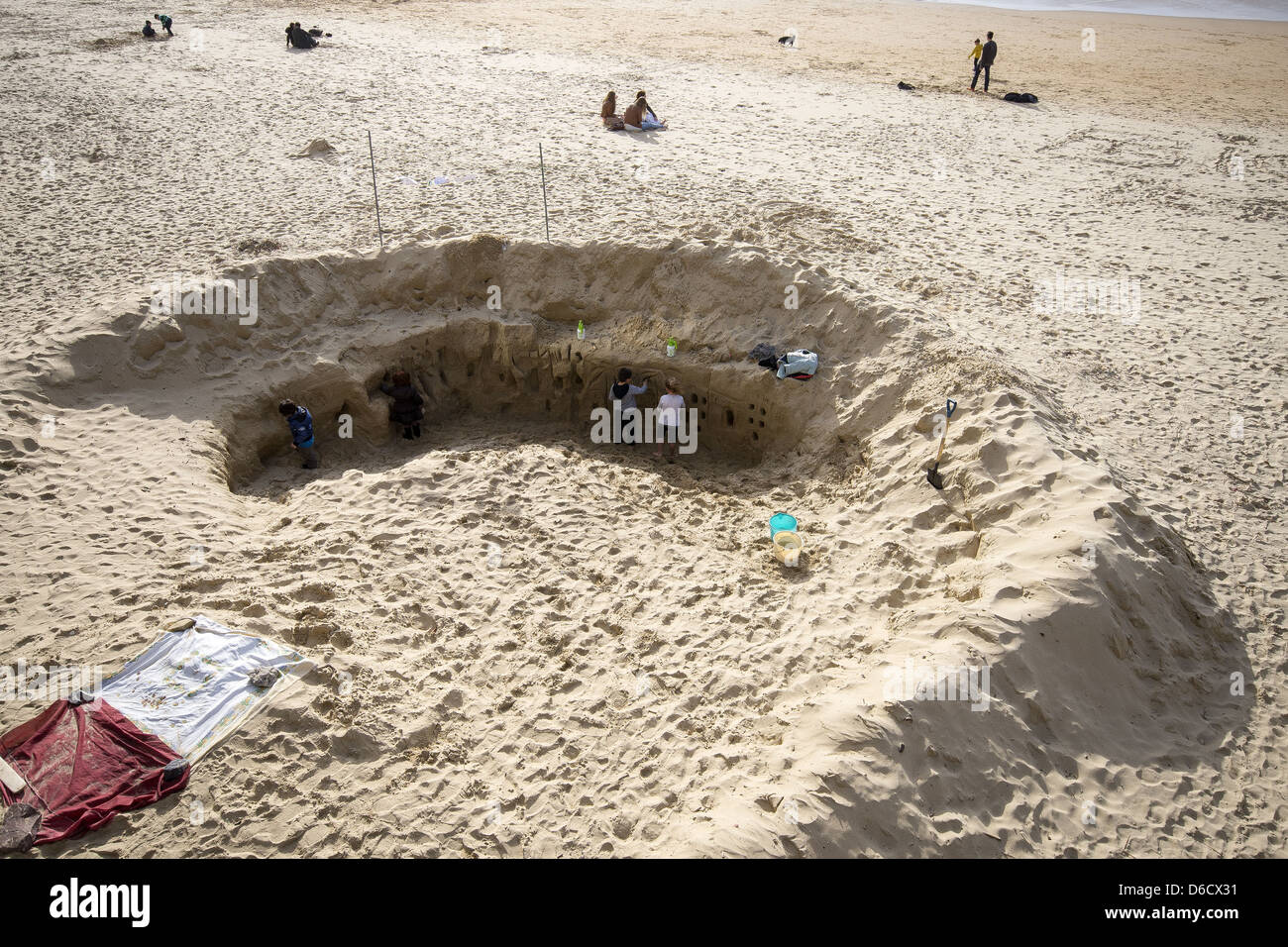 Children digging out a giant hole on San Sebastián beach, Basque Country, Spain Stock Photo Alamy