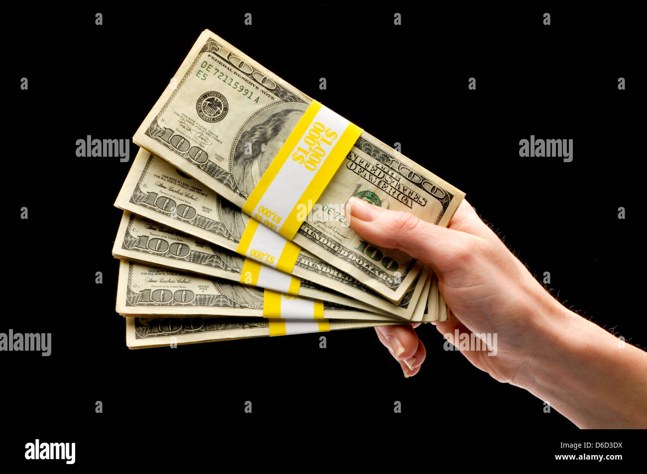 hand holding stackf of us currency Stock Photo