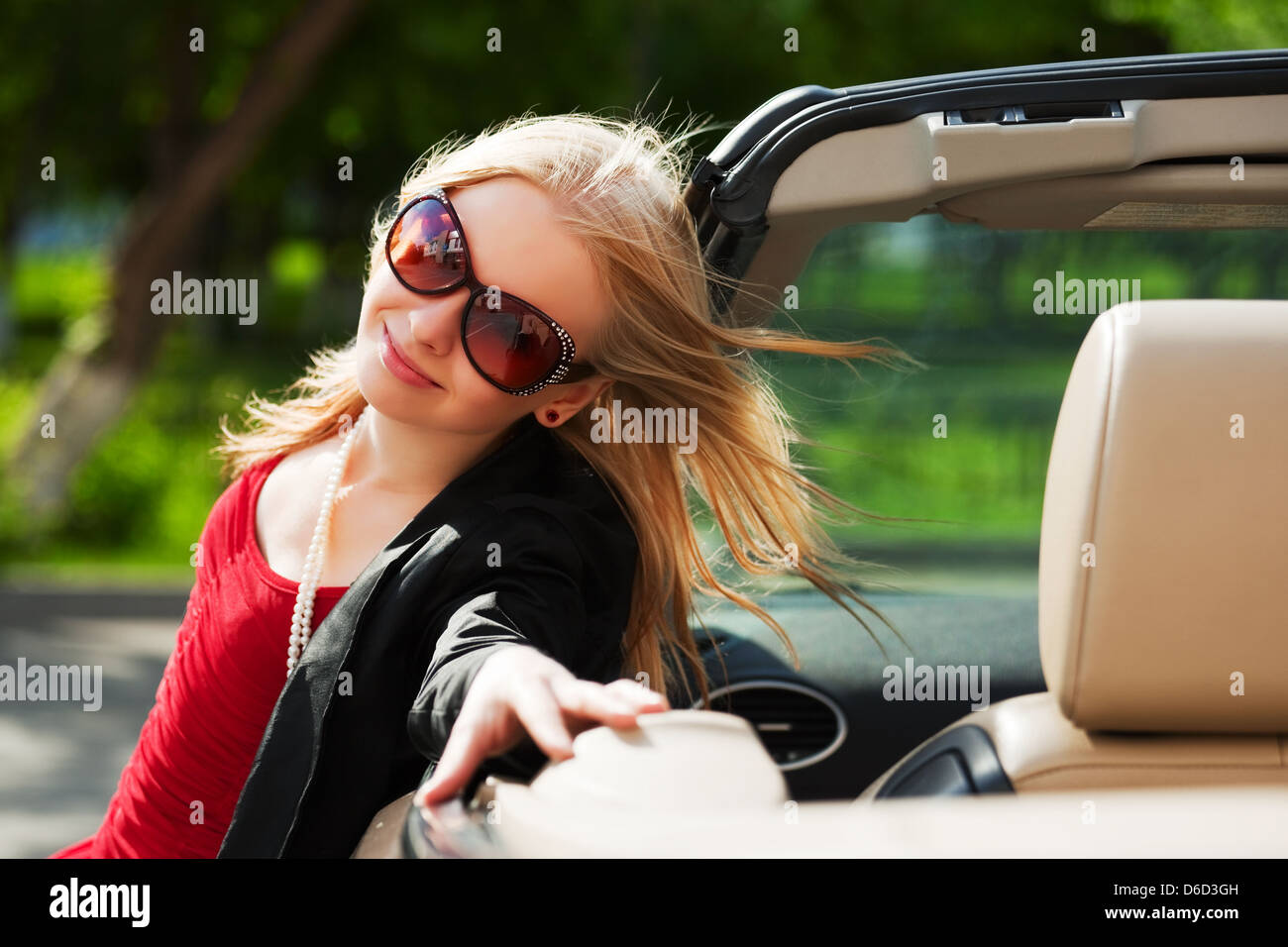 Young woman with a convertible car Stock Photo - Alamy