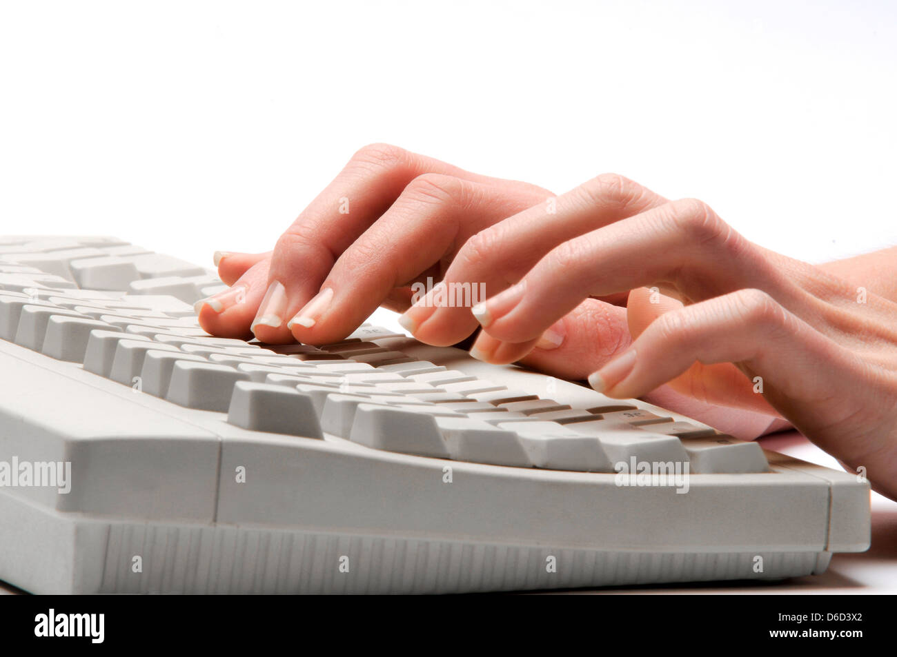 hands typing on keyboard Stock Photo