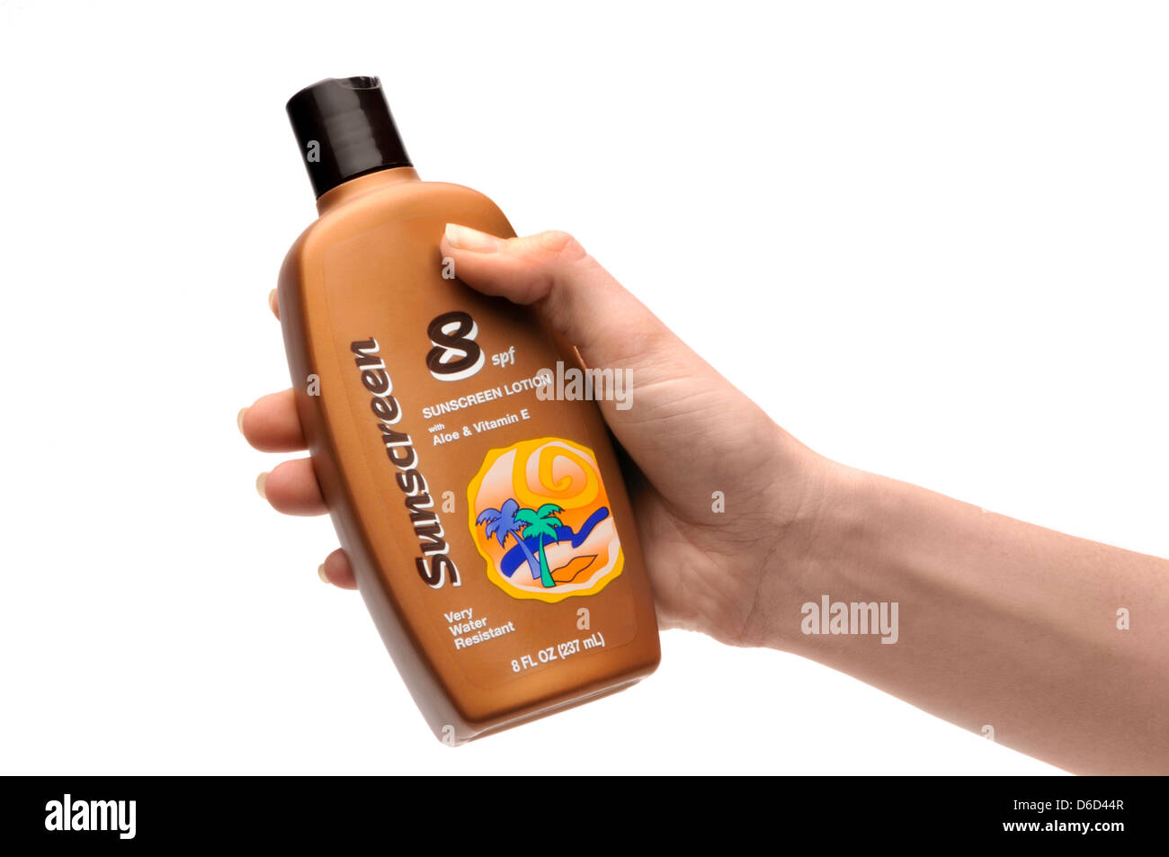 hand holding bottle of sun screen lotion Stock Photo