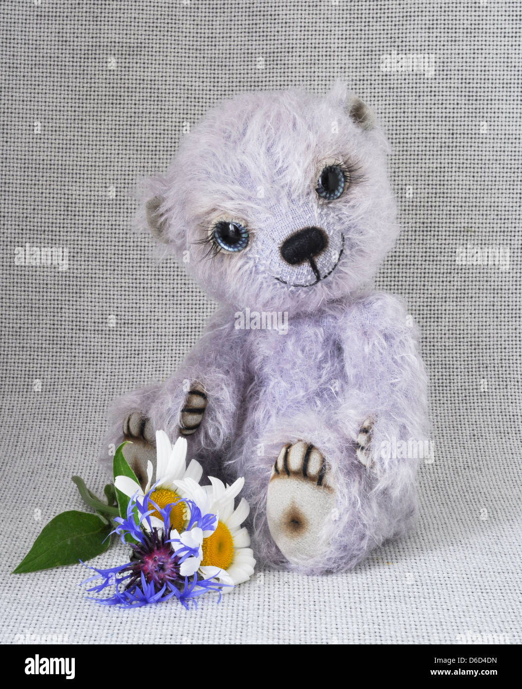 Lilac teddy-bear with a bunch of Stock Photo