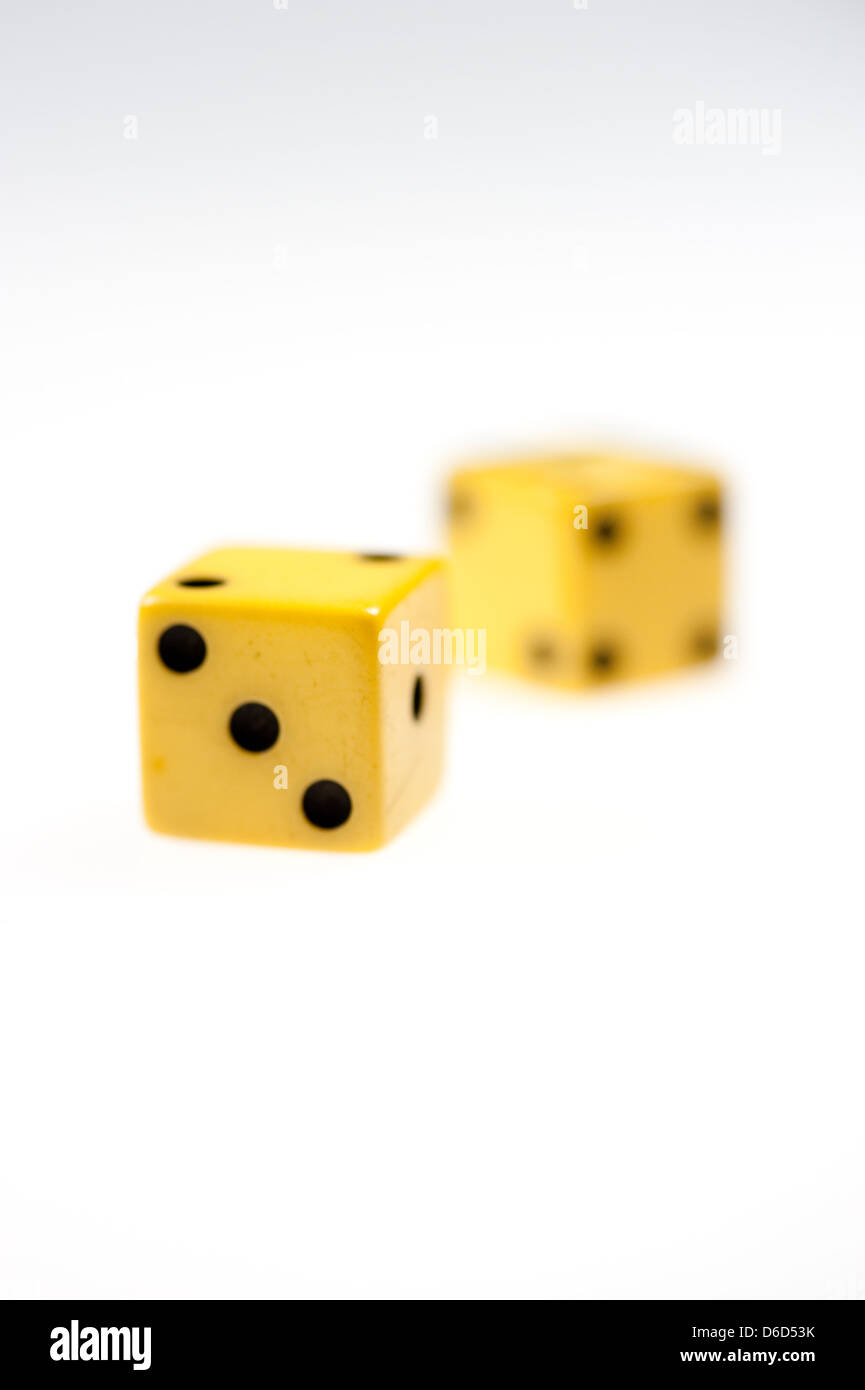 Pair of antique, ivory dice isolated on a bright white background Stock