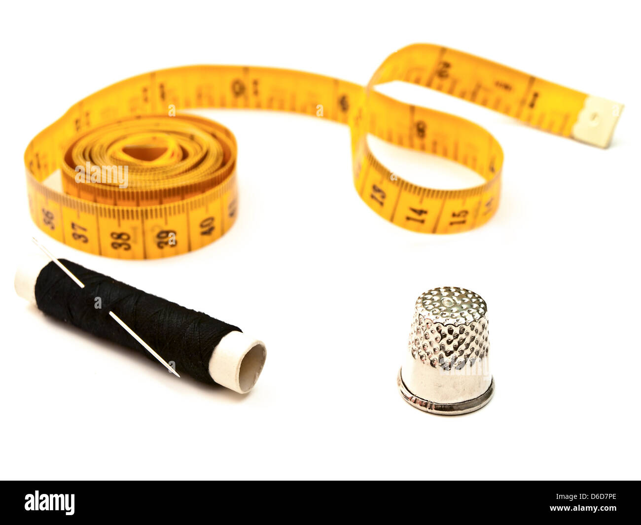 tailor meter, thimble,and black thread Stock Photo