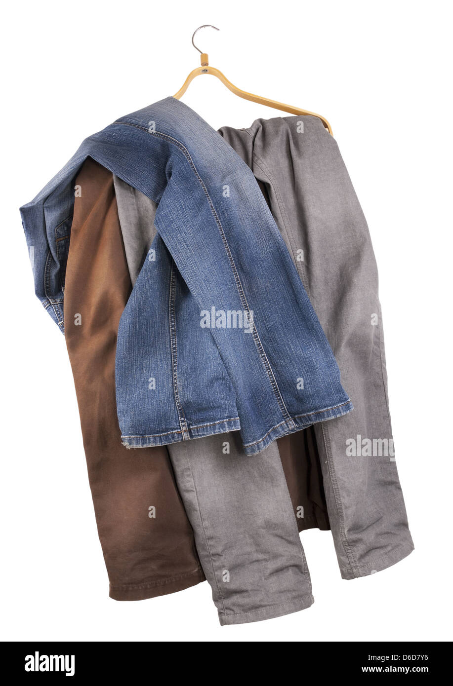 Old shabby  jeans hang on a hanger Stock Photo