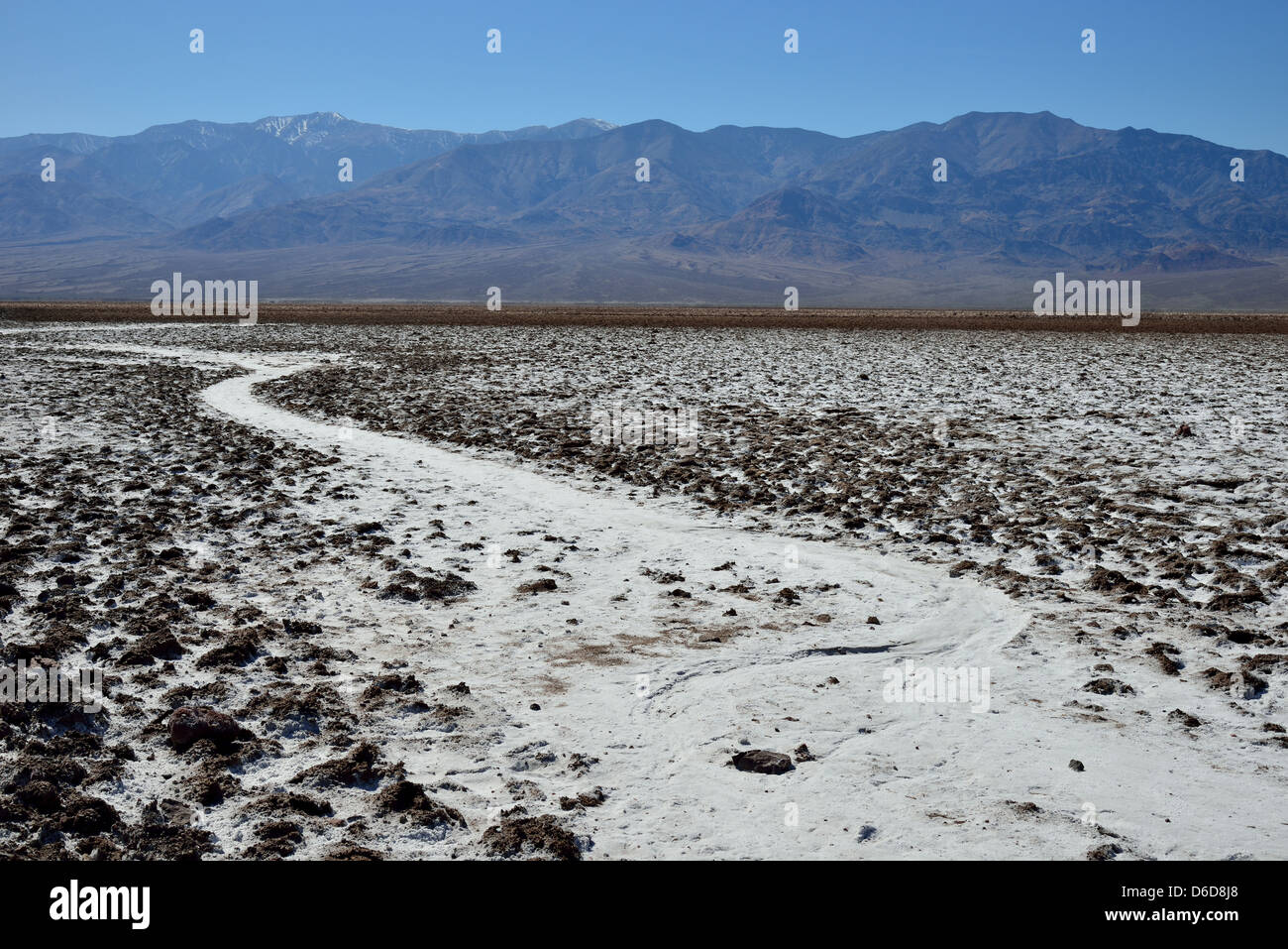 A dried creek covered by white rock salt at the Badwater Basin. Death Valley National Park, California, USA. Stock Photo