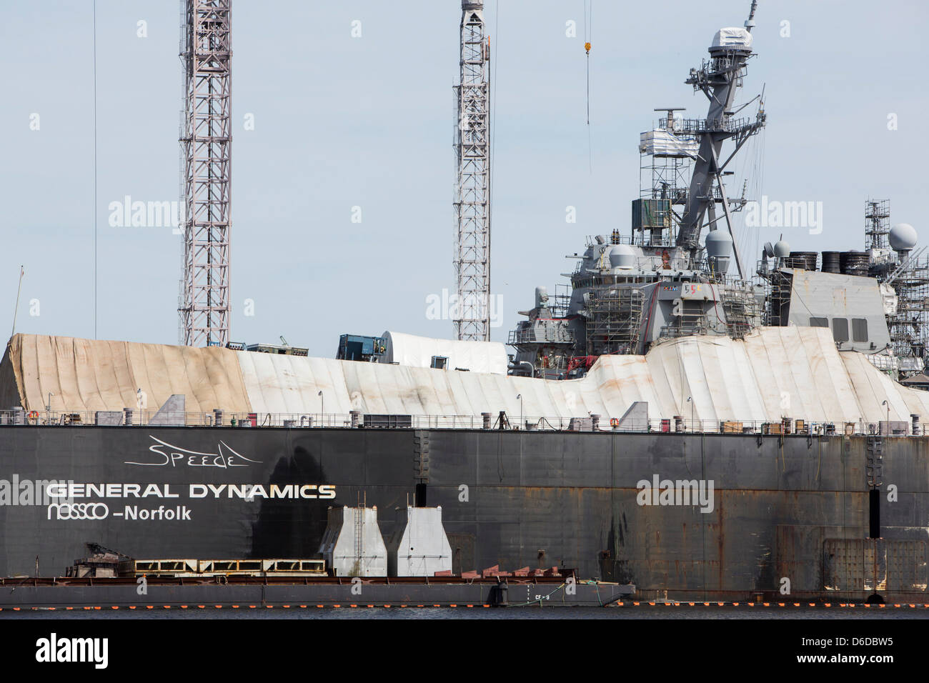 An Arleigh Burke class destroyer can be seen in a repair dry dock at the General Dynamics NASSCO shipyard in Norfolk, Virginia Stock Photo
