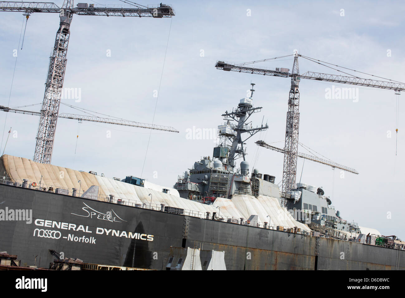 An Arleigh Burke class destroyer can be seen in a repair dry dock at the General Dynamics NASSCO shipyard in Norfolk, Virginia Stock Photo