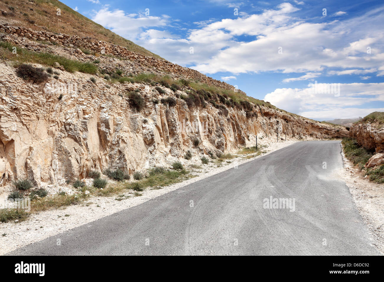Mountain landscape with road and cloudy sky Stock Photo - Alamy