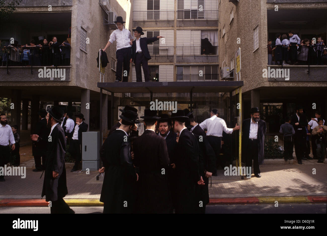 Ultra Orthodox religious Jews gathered at a neighborhood as they prepare for a funeral of a rabbi in the city of Bnei Brak or Bene Beraq a center of Haredi Judaism in Israel Stock Photo