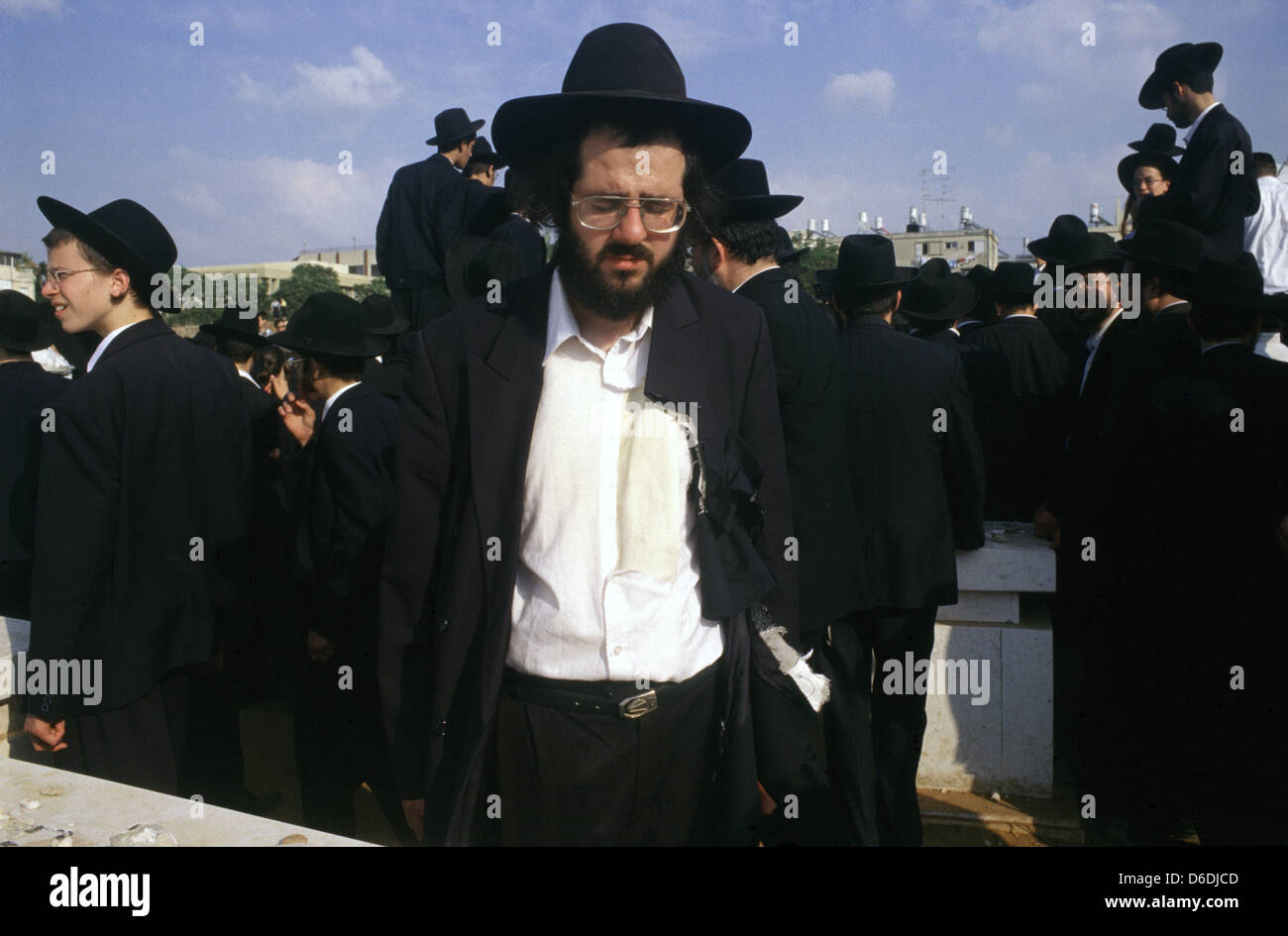 Ultra Orthodox Jews with ripped clothes as a gesture of mourning at a