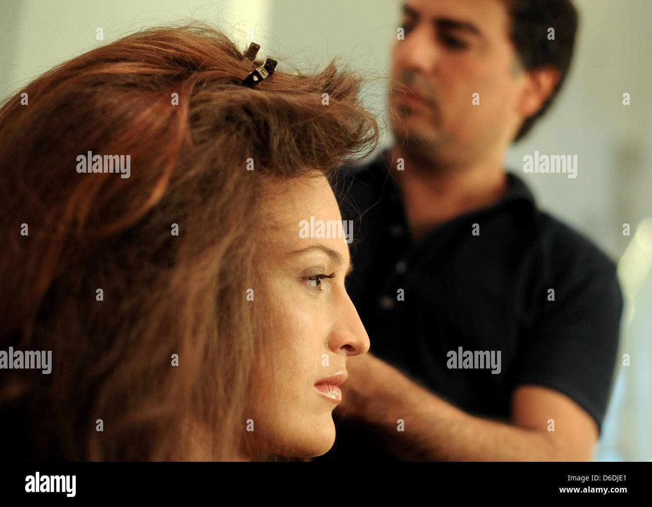 dpa-exclusive - Hair and make-up stylist  Shan Rahimkhan styles the hair of plus-size model Linda Meißner for the fashion shoot of the fashion label Unrath & Strano, in his studio in Berlin, Germany, 5 September 2012. In the photo shoot, the model with a UK size 14 (US size 12) presents the winter collection of Unrath & Strano. The fashion label designs and produces women's clothin Stock Photo