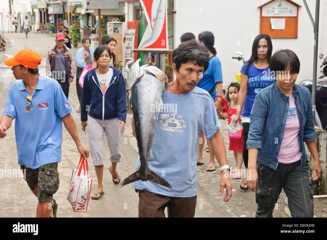 Asian fisherman carries a freshly caught big Wahoo fish Acanthocybium solandri on the street followed by many people, Sabang Asia Stock Photo