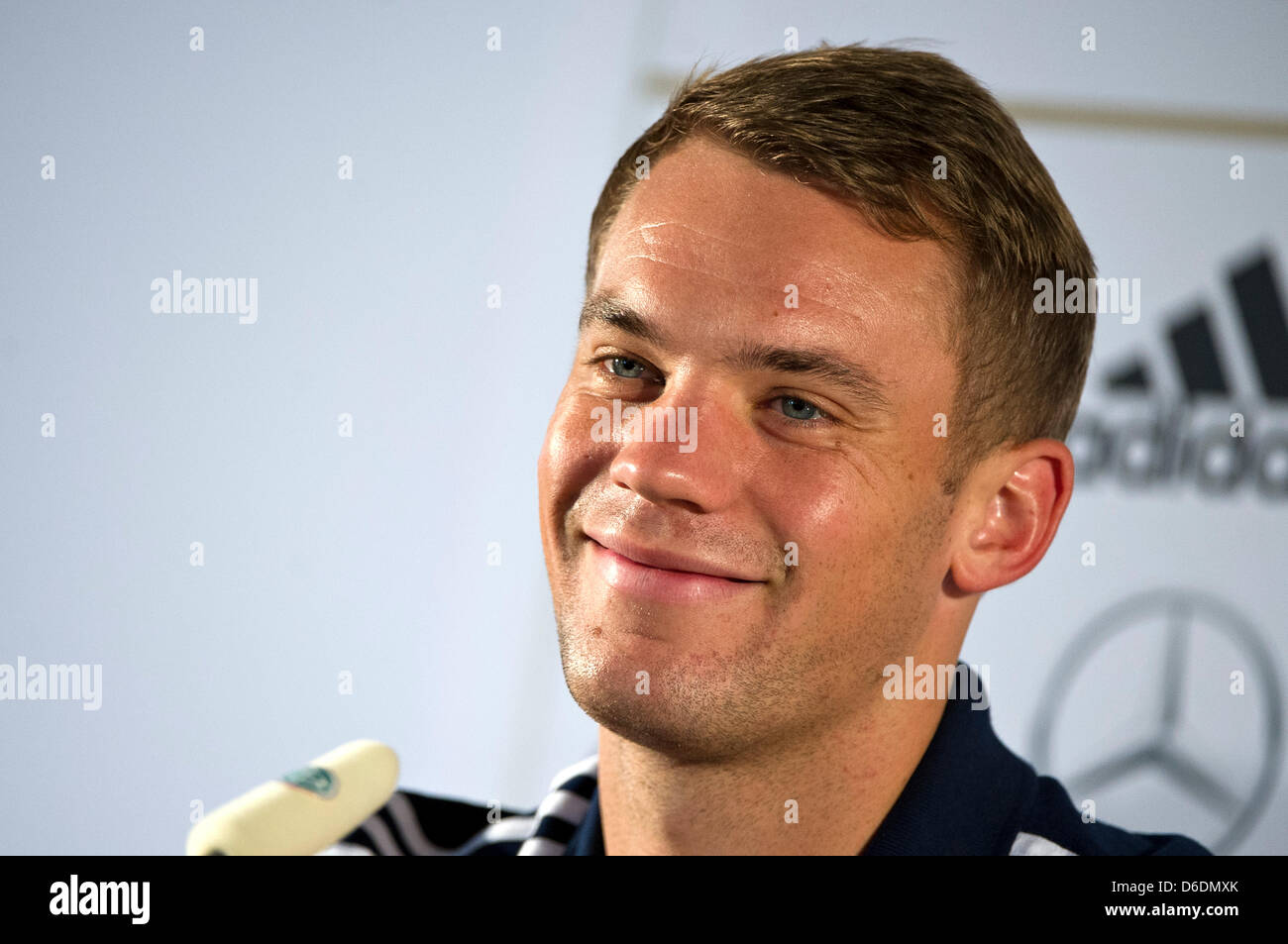 German national soccer goal keeper Manuel Neuer smiles during a press conference of the German Football Association (DFB) in Barsinghausen, Germany, 09 September 2012. The DFB team is currently preparing for an international soccer match against Austria which will be played in Vienna on 11 September 2012. Photo: EMILY WABITSCH Stock Photo