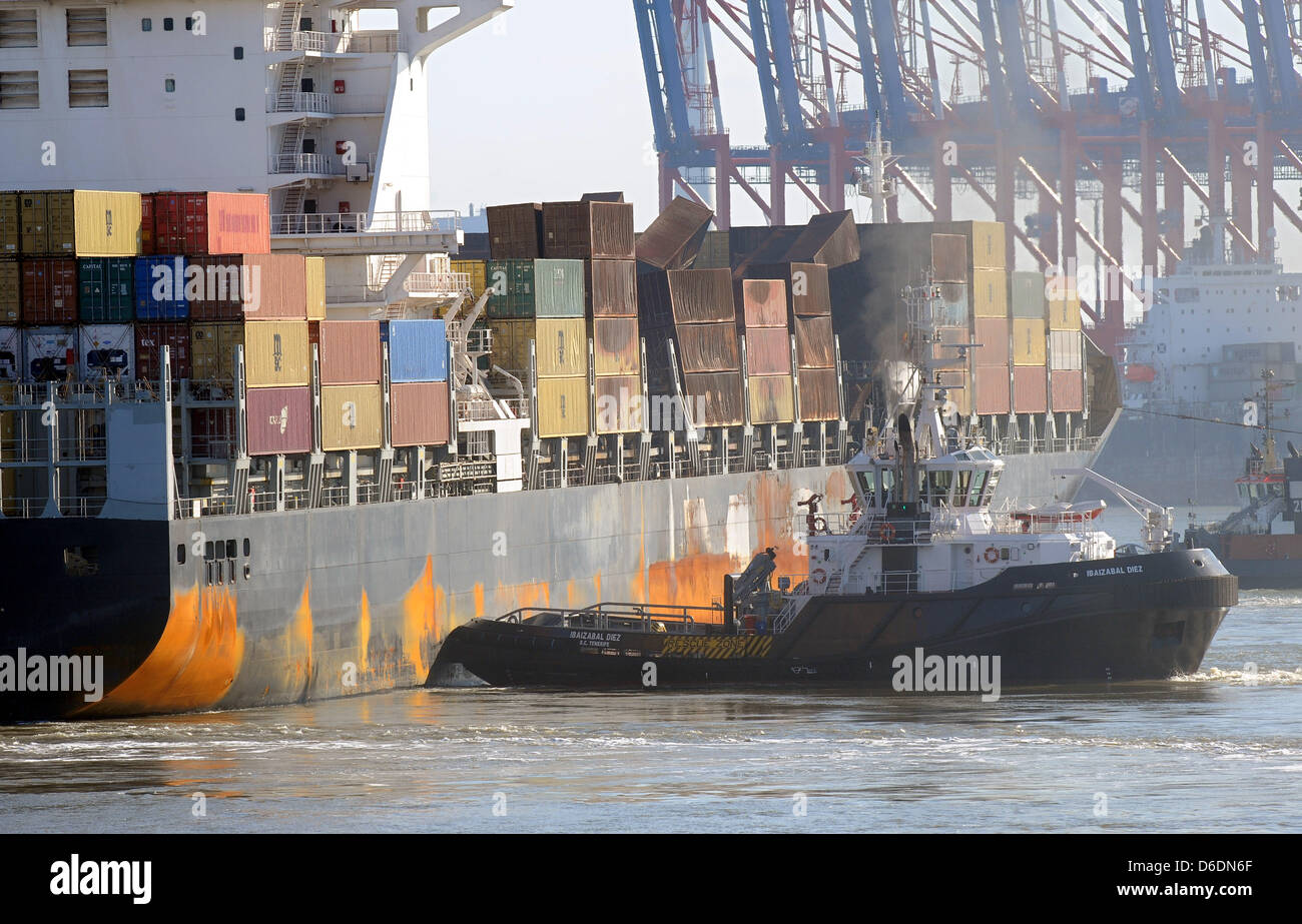 Heavily damaged container ship MSC 'Flaminia' arrives at the JadeWeserPort towed by tugboats in Wilhelmshaven, Germany, 09 September 2012. The ship caught fire on the Atlantic in June. The ship carrying some containers with dangerous load was then towed from the Sout-West coast of Great Brtiain to Wilhelmshaven. Photo: INGO WAGNER Stock Photo