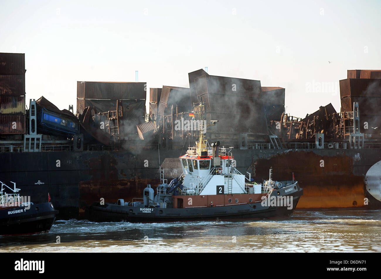 Heavily damaged container ship MSC 'Flaminia' arrives at the JadeWeserPort in Wilhelmshaven, Germany, 09 September 2012. The ship caught fire on the Atlantic in June. The ship carrying some containers with dangerous load was then towed from the Sout-West coast of Great Brtiain to Wilhelmshaven. Photo: INGO WAGNER Stock Photo