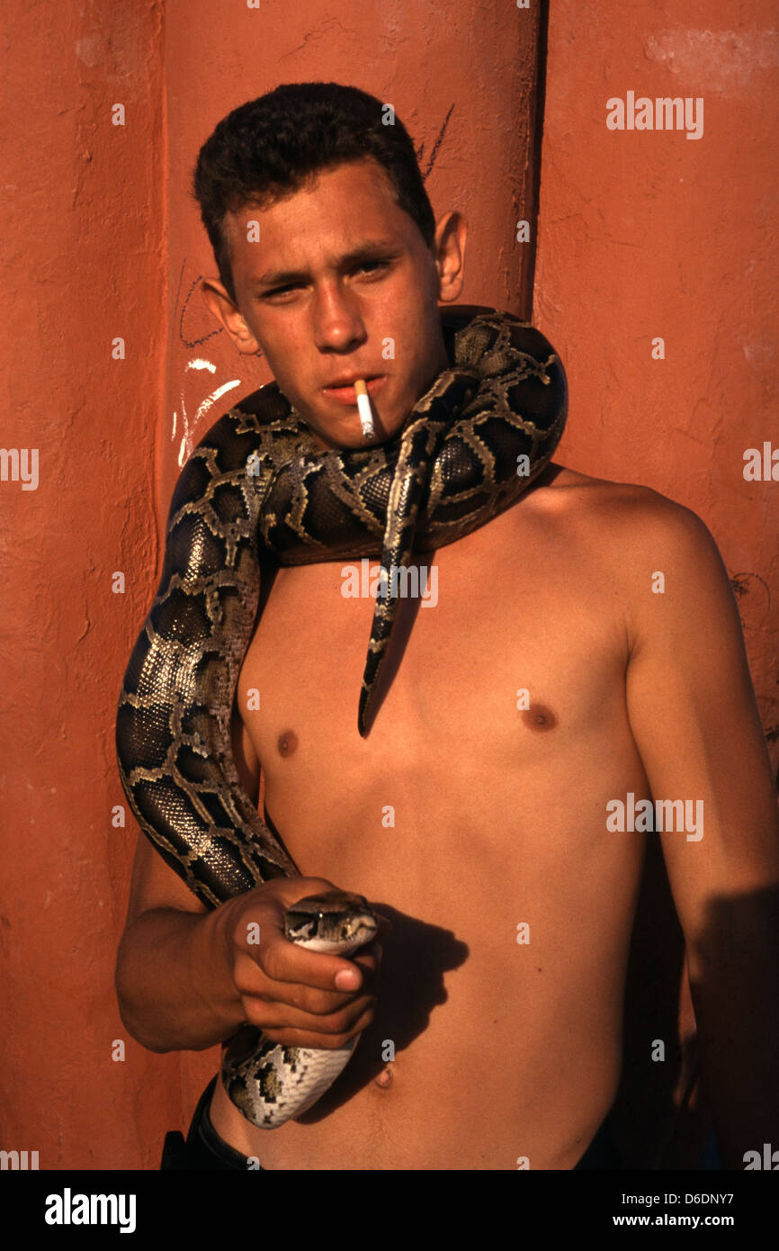 A youngster with snake wrapped around him in Tel Aviv Israel Stock Photo
