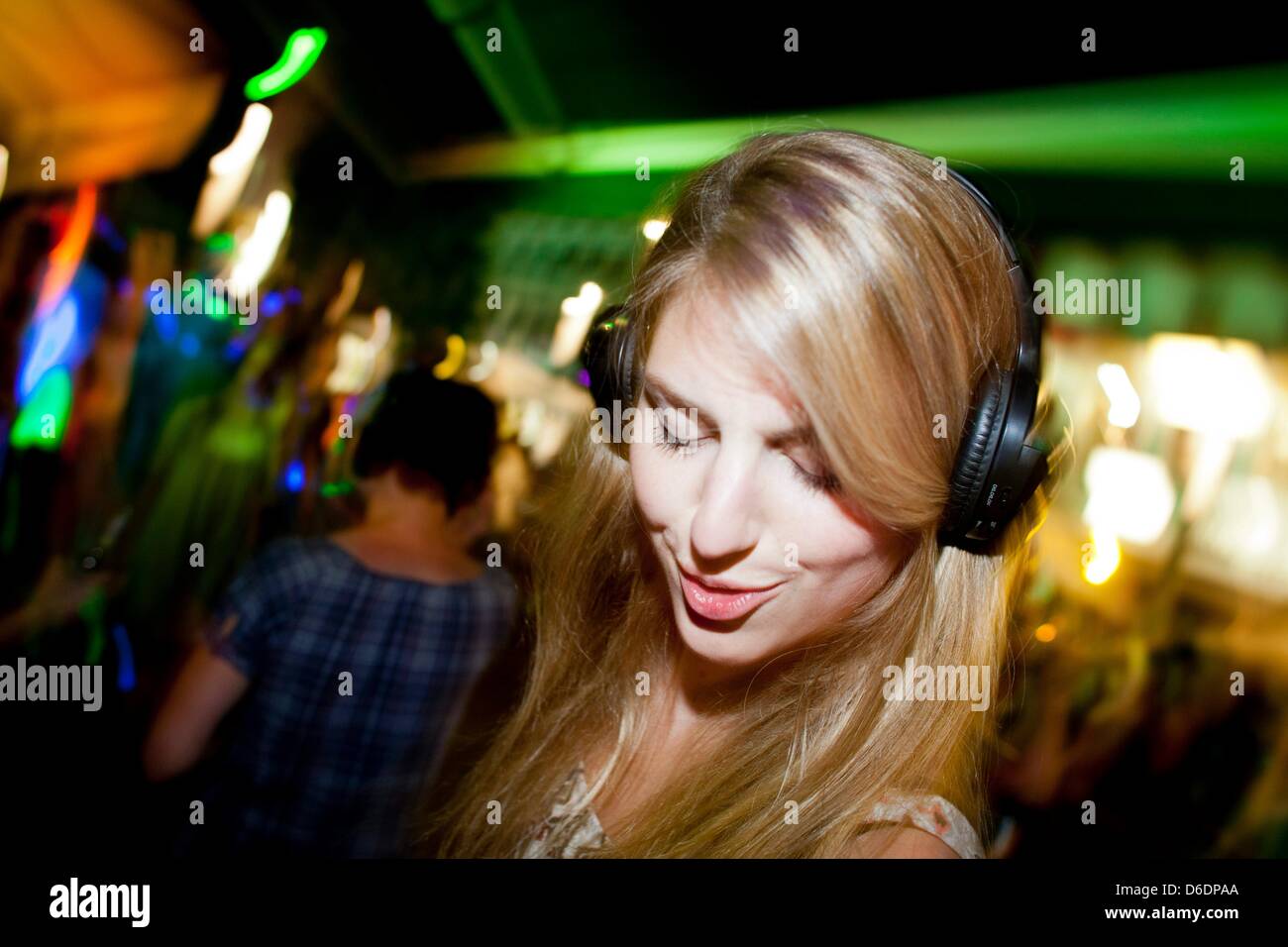 Eva dances during a headphone party at the Club Ullrich in Bochum