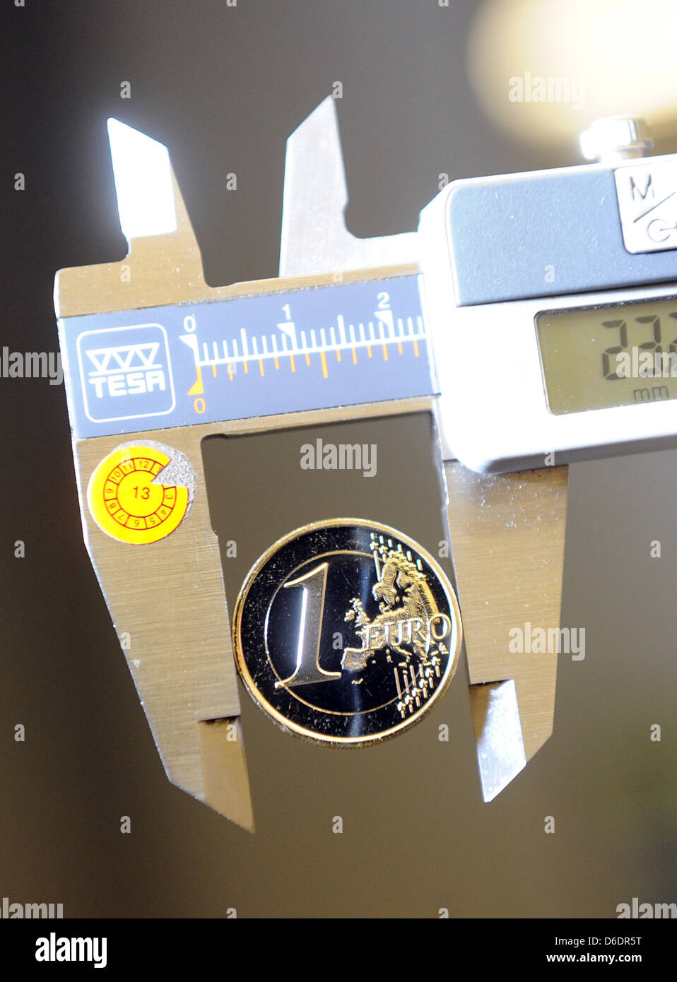 A one-euro coin is measured at the State Minit in Karlsruhe, Germany, 11  September 2012. Up to 1.5 million coins can be manufactured a day at the  smallest of the five mints