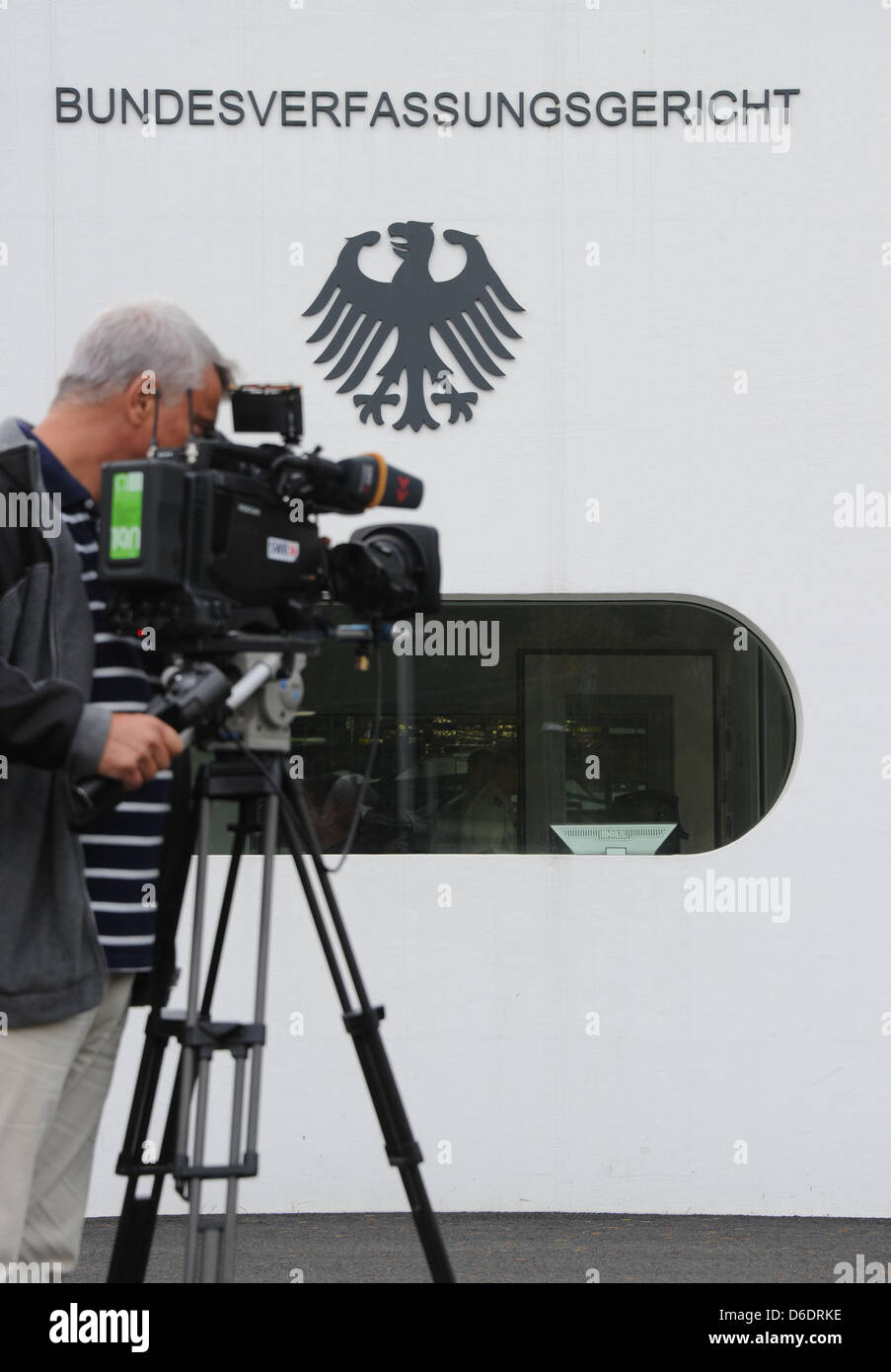A cameraman films the Federal Constitutional Court of Germany (BVerfG) in Karlsruhe, Germany, 12 September 2012.  The BVerfG will on the same day announce its verdict on the permanent European Stability Mechanism and the European fiscal pact. Photo: ULI DECK Stock Photo