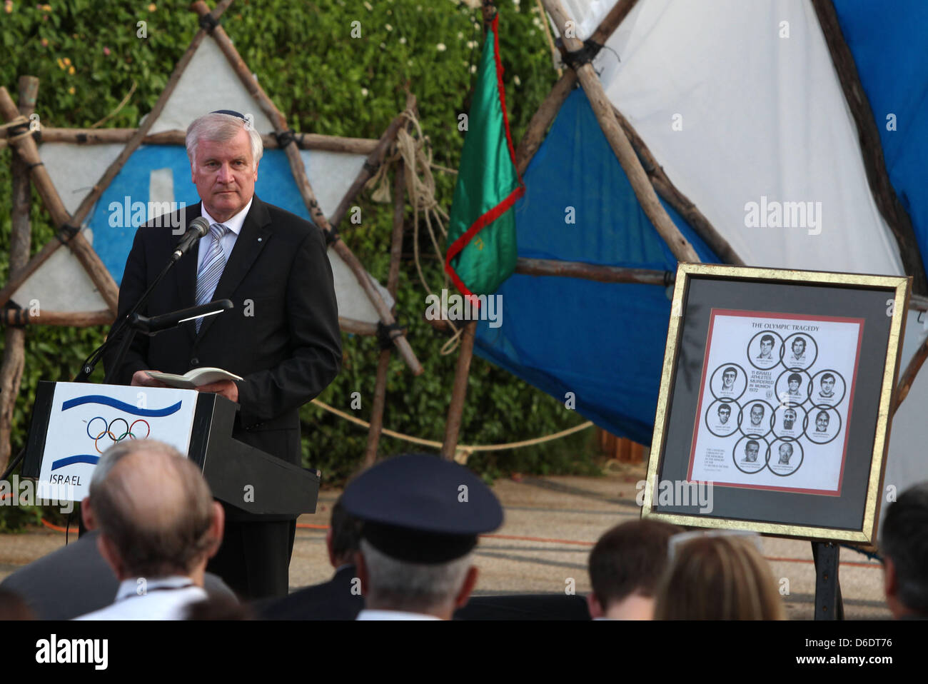 Premier of Bavaria and President of the German Bundesrat Horst Seehofer talks next to pictures of the victims of the 1972 Munich Olympic Games assassinations in Tel Aviv, Israel, 12 September 2012. The victims were remembered during the service. Seehofer in his function as the President of the German Bundesrat is visiting Israel from 10 until 12 September 2012 and the Palestinian T Stock Photo