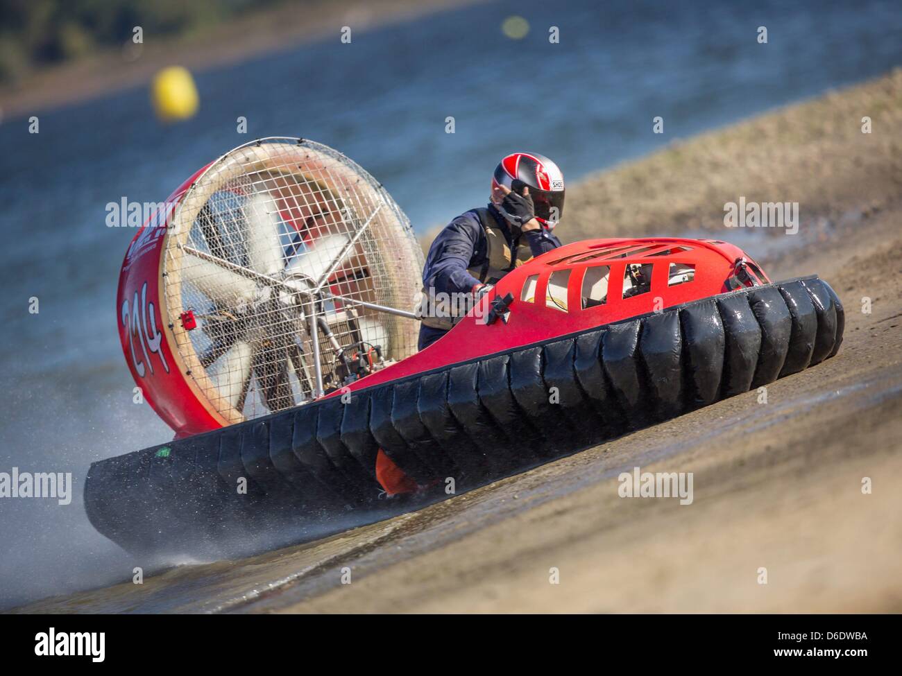 A hovercraft driver speeds along the race course at the ...